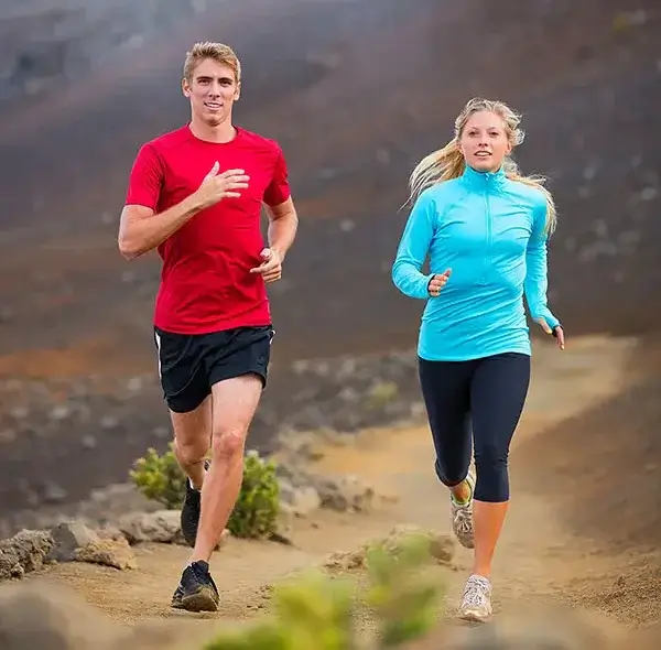 Athletes running on a mountain trail, illustrating endurance and fitness ideal for promoting sports IV therapy.